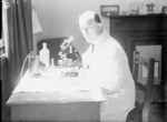 Surgeon Commander C. A. Green of Royal Navy Medical School at a microscope, Clevedon, Somerset, England, United Kingdom, 1944