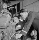 Chinese Navy Ensign Chen Kah (left) and Ensign Sung Chi-Huang (right) studying a piece of equipment, Chatham Gunnery School, England, United Kingdom, Aug 1945