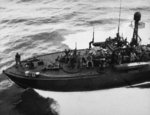 Elco 80-foot PT-523 alongside escort carrier USS Manila Bay returning downed pilot and aircrewman east of Leyte Gulf, 22 Oct 1944. Note the aircraft style National insignia on top of the chart house.