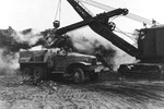 US Navy 62nd SeaBees engaged in moving steaming volcanic rock and ash on Iwo Jima, Bonin Islands, Mar 1945. Note International Harvester two-and-a-half-ton truck.