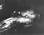 Crews apply water to smoldering fires on the hangar deck of the USS Randolph after a P1Y Ginga special attack bomber crashed into the ship while at anchor in Ulithi Lagoon, Caroline Islands, 11 Mar 1945.