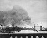 Smoke rising from the Surrey Docks, London, England, United Kingdom, 8 Sep 1940, the morning after the opening night of “The Blitz” bombings as seen from London Bridge. Note Tower Bridge silhouetted against the smoke.