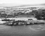 The battleship USS Oklahoma, capsized in the Pearl Harbor Attack on 7 Dec 1941, is righted to about 30-degrees during her salvage work, 29 Mar 1943. Photo 1 of 2.