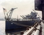 Battleship USS West Virginia, sunk in the Pearl Harbor Attack 7 Dec 1941 and then given temporary repairs at Pearl Harbor, is about to leave Hawaii for further repairs in the United States, 30 Apr 1943. Photo 2 of 3.