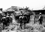 Men of US Marine Corps 6th Division entering Naha, Okinawa, 17 May 1945