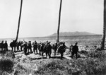 Japanese troops arriving on Guadalcanal, circa early Sep 1942; note Savo Island in background