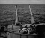 Sailors atop a 5-inch gun turret aboard USS New Jersey, Pacific Ocean, 21 Jul 1943