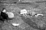 A young boy sitting next to his dead mother, recently killed by strafing German aircraft, near Jana Ostroroga Street in Warsaw, Poland, 13 Sep 1939