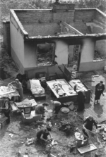 Albert Turowski (boy) and his family outside of their bombed out home, Warsaw, Poland, Sep 1939