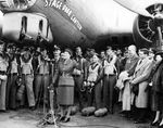 Mary Churchill, daughter of the Prime Minister, holding up a bottle of Coca-Cola just before she cracked it over the machine gun barrels of the B-17G “Stage Door Canteen” as a christening, 21 Apr 1944 at Ridgewell.