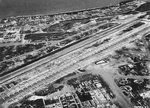 119 B-29 Superfortress bombers of the 73rd Bomb Wing lined up on Baker runway, Isley Field, Saipan, Mariana Islands, Sep 1945 with 35 more B-29s seen in the periphery.