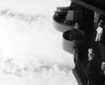 A view off the stern of the USS Bunker Hill during a one-day speed run from Boston, Massachusetts to Norfolk, Virginia, 4 Sep 1943. Note the civilian yard worker in the white hat.