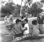 Captain Edward Steichen, head of the United States Navy’s photographic unit, interacting with children on Guam, Mariana Islands, May 1945.