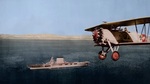 United States Navy Fighting Squadron 2-B Commander J.J. Clark flying a Boeing F-3B past the carrier USS Lexington (Lexington-class), circa 1931, probably along the California coast.