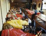 Members of the British Womens Auxiliary Air Force (WAAF) at an RAF glider station repair and pack colored parachutes for use by airborne troops during the Normandy invasion, 31 May 1944.