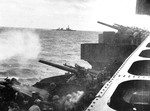 Cruiser USS Northampton firing her 5-inch guns in a bombardment of Wotje in the Marshall Islands, 1 Feb 1942. Note cruiser Salt Lake City in the background. Page 2 of 2.