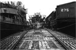 A deck level view of the back of the conning tower of captured German submarine U-505 shortly after arrival at Bermuda, 19 to 29 Jun 1944. Fleet tug USS Abnaki is at left and covered lighter YFN-275 is at right.