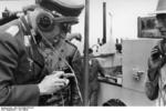 Fritz Todt on the radio in a Panzerkampfwagen III tank while observing the preparation of German forces on the French coast for the invasion of Britain, fall 1940