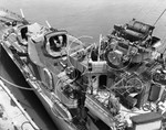 Open backed forward turrets for the single-mounted 5”/38 caliber guns on the destroyer USS Mahan at the Mare Island Naval Yard, 24 Jun 1944. Note the Mark 33 gun director with fire control radar in the upper right.