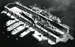 Cruiser USS Nashville in floating drydock ABSD-1 at Espiritu Santo, New Hebrides late Jun 1944. Nashville was having hull damage repaired after a close bomb near-miss in the Bismarck Sea on 4 Jun 1944.