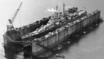 Cruiser USS Cleveland in floating drydock ABSD-1 at Pallikulo Bay, Espiritu Santo, New Hebrides, 13 Jan 1944. Cleveland was the first warship to enter ABSD-1.