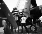 Ordnancemen aboard USS Hancock loading 5-inch HVAR rockets onto the wings of F4U Corsairs before taking off for a strike on Kyushu, Japan, 21 Mar 1945. Photo 1 of 2.