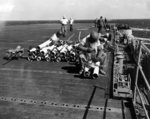 Ordnancemen aboard USS Hancock adjusting fins on 5-inch HVAR rocket motors, 21 Mar 1945.