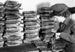 WAAF armourer belting up ammunition for a Lancaster bomber, RAF Coningsby, Lincolnshire, England, United Kingdom, Feb 1944