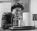 WAAF Leading Aircraftwoman M. Wishart taking a weather reading from a thermohygrograph, RAF Pitreavie Castle, Dunfermline, Scotland, United Kingdom, Dec 1943