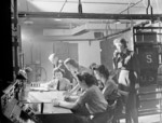 Flight Officer P. M. Wright supervising Sergeant K. F. Sperrin and WAAF operators Joan Lancaster, Elaine Miley, Gwen Arnold, and Joyce Hollyoak in the receiver room at RAF Bawdsey, Suffolk, England, United Kingdom, date unknown