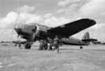 WAAF flight mechanics pulling the chocks from the wheels of a Beaufort Mark I aircraft of No. 51 Operational Training Unit before a training flight from RAF Cranfield, Bedfordshire, England, United Kingdom, 1944; note a Beaufighter Mark VI aircraft in background