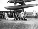 Funeral service on the fantail of the USS Honolulu on 7 Jul 1943 for F1c Irvin Edwards, a USS Helena crewman who died of his wounds. RAdm Walden Ainsworth stands with other Helena crewmen. Photo 1 of 2.