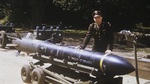 United States Army Air Forces Major Byron Trent, commanding officer of the 333rd Bomb Squadron, 94th Bomb Group at RAF Bury St. Edmunds, Suffolk, England with a Disney Bomb on a bomb lifting carriage, 1945.