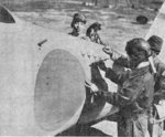 A Japanese pilot marking a victory on his A6M Zero fighter, 14 Feb 1942; note his unit