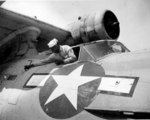 US Navy African-American mechanic Alvin V. Morrison working on PBY Catalina aircraft at Naval Air Station Seattle, Washington, United States, 27 Apr 1944