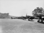 Australian Boomerang fighter of No. 5 Squadron RAAF taxiing past RNZAF F4U-1 Corsair fighters, Cape Torokina, Bouganville, Solomon Islands, 15 Jan 1945