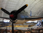 F6F-3 Hellcat fighter on display at the Smithsonian Air and Space Museum Udvar-Hazy Center, Chantilly, Virginia, United States, 26 Apr 2009, photo 2 of 4; note B-29 bomber Enola Gay in background