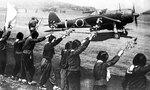 High school girls waving cherry blossom branches to bid farewell to Lieutenant Toshio Anazawa of Japanese Army 20th Shinbu Squadron in Ki-43 Hayabusa, Chiran Airfield, Kagoshima Prefecture, Japan, 12 Apr 1945; Anazawa died in action west of Okinawa, Japan later on the same day at the age of 23