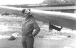 US Navy VS-44 Lt. (jg) J. M. Stubblebine posing with his OS2U Kingfisher aircraft, damaged after losing power at takeoff and hitting a fence, Hato Field, Curaçao, Dutch West Indies, 13 Nov 1943