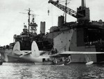 PBM-3 Mariner aircraft of US Navy patrol bomber squadron VPB-210 being prepared for hoisting aboard seaplane tender Albemarle, Guantanamo Bay, Cuba, 5 Jan 1945