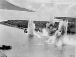 US B-25D bomber being destroyed by the blast of a bomb of a preceding friendly bomber, Hansa Bay, Australian New Guinea, 28 Aug 1943, photo 2 of 3