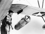 Removing a Mark XVII depth bomb from SOC Seagull aircraft of cruiser Philadelphia, 2 Jul 1942, photo 2 of 2