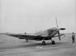 Spitfire HF.VII fighter being used for evaluation of stability and flight control by the Americans at Langley Research Center, Virginia, United States, 7 Sep 1944; note B-24 in far left background