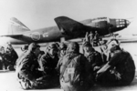 Japanese Navy aviators resting; note G4M2e Model 24 bomber with MXY7 Ohka Model 11 aircraft in background