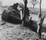 An American soldier looking at a knocked out German Jagdtiger tank, Morsbronn-les-Bains area, Alsace, France, Mar 1945