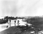 US Army soldiers unloading LCPR and LCM type landing craft on the beach at Massacre Bay, Attu, Aleutian islands, 12 May 1943; note military policemen on right side of photo