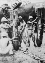 Japanese bomber crew preparing bombs before a mission in Hunan Province, China, 8 Sep 1944; bomb on right of photo noted 