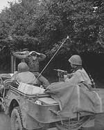 Two German prisoners being taken to the 6th Division Prisoner of War Encampment, Brest, France 28 Aug 1944