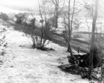 Two soldiers of US 101st Airborne Division manning a forward post near a road, near Bastogne, Belgium, 23 Dec 1944