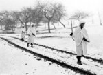 US Army Sergeant James Storey, Private Frank Fox, and Corporal Dennis Lavanoha on a scouting mission, Lellig, Luxembourg, 30 Dec 1944; note bedsheets used for camouflage